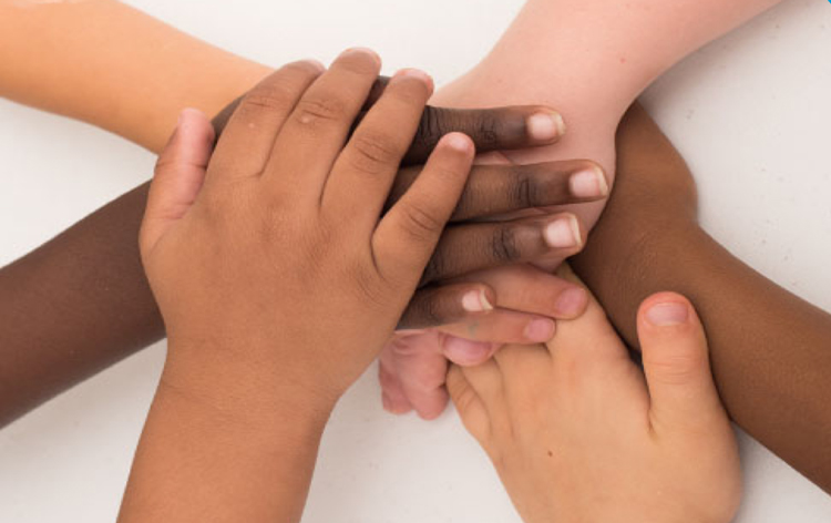 kids hands stacked on top of each other